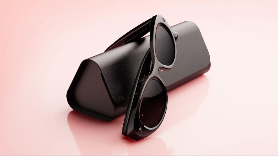 Black oval Meta Glasses by Kylie beside their folding case